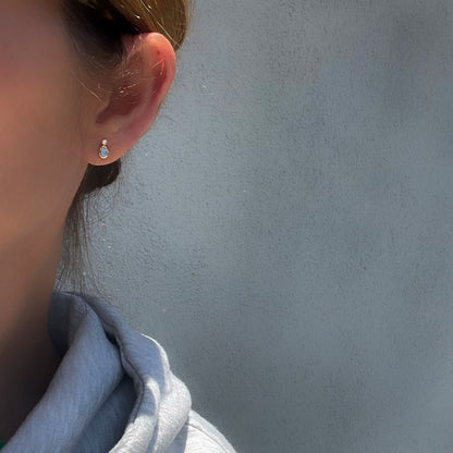Model wearing Moonstone Earrings by NIXIN Jewelry. Blue moonstone earrings with tiny diamonds set in 14k gold.