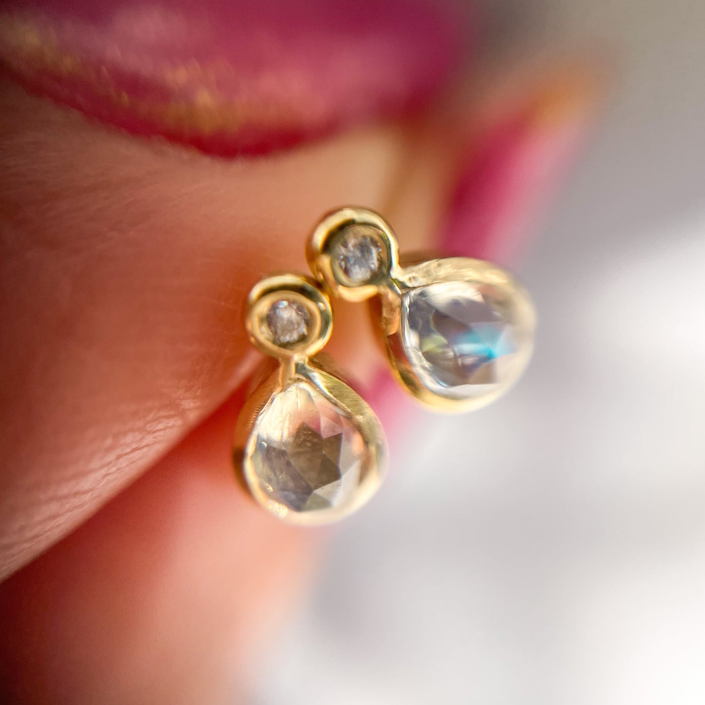 Moonstone Earrings by NIXIN Jewelry shown under magnification and shot from above to show their rose cut faceting. Made in 14k gold.
