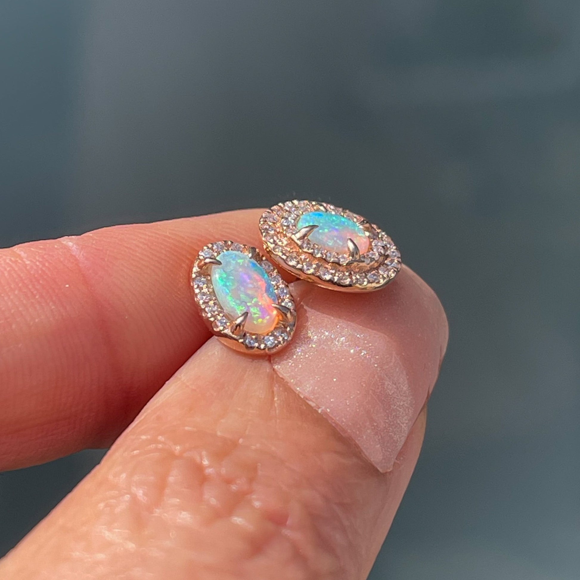 A profile view of Australian Opal Earrings by NIXIN Jewelry showing the low profile of the opal stud earrings.