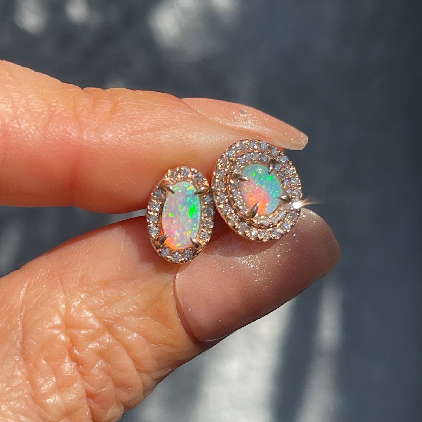 A pair of Australian Opal Earrings by NIXIN Jewelry with asymmetrical opals to make mismatched earrings.