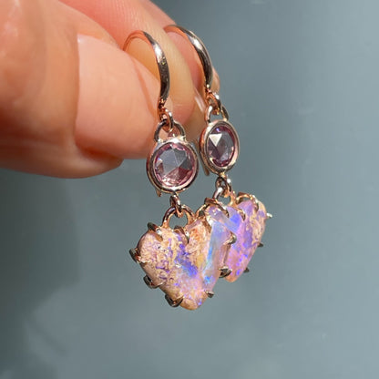 A pair of Australian Opal Earrings by NIXIN Jewelry. Opal drop earrings with purple sapphires.