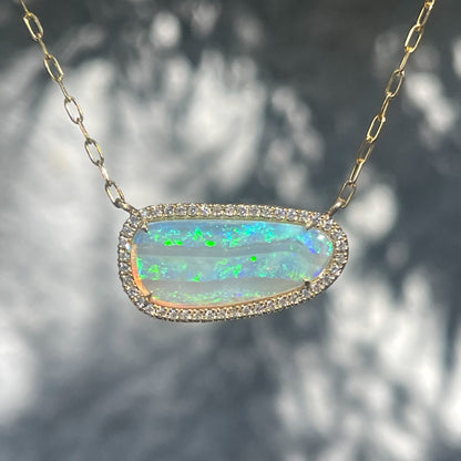 An Australian Opal Necklace by NIXIN Jewelry with a green opal set in 14k gold with pave diamonds.