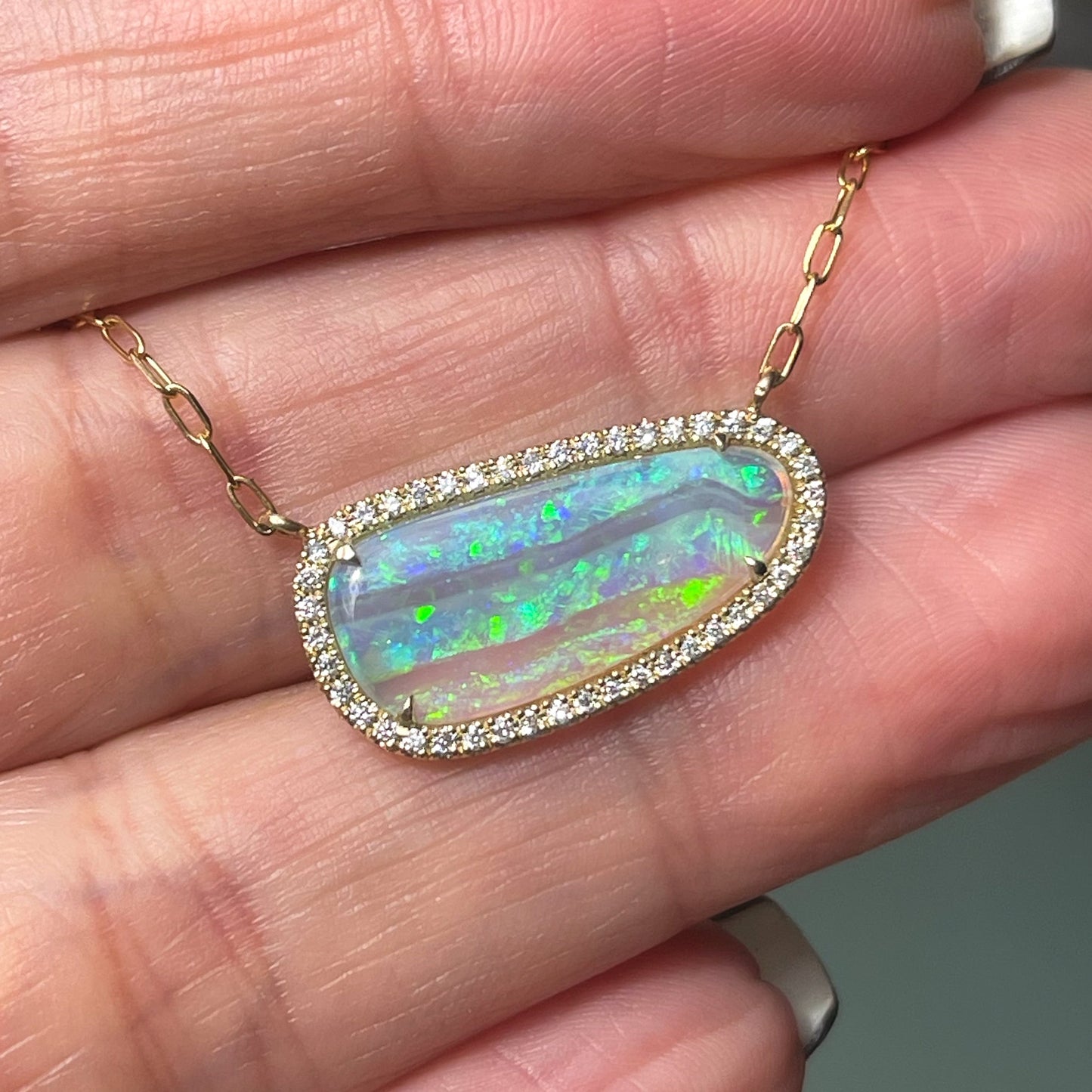 An Australian Opal Necklace by NIXIN Jewelry with a Crystal Opal surrounded by pave diamonds.