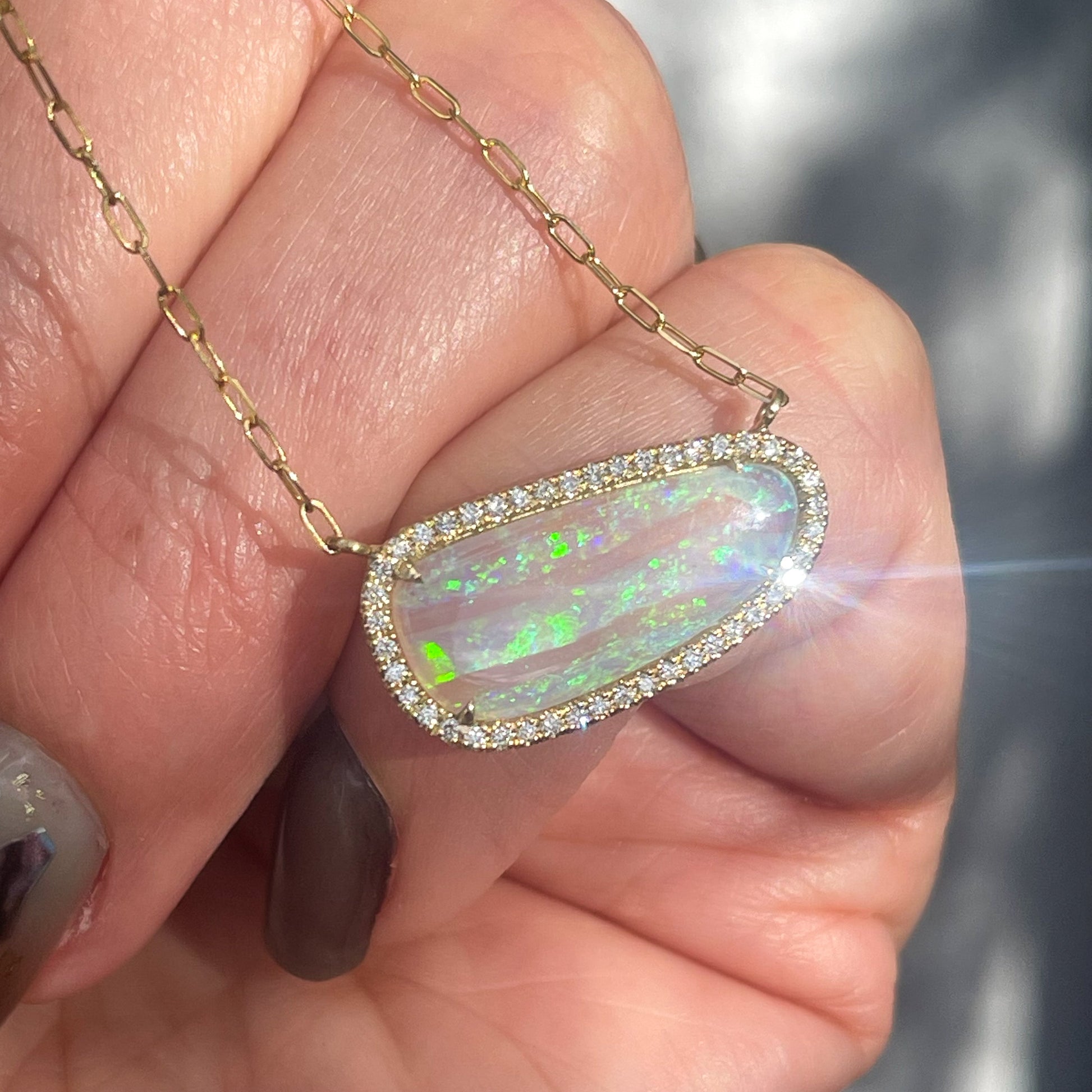 An Australian Opal Necklace by NIXIN Jewelry with a diamond halo around a Crystal Opal. A unique opal necklace.