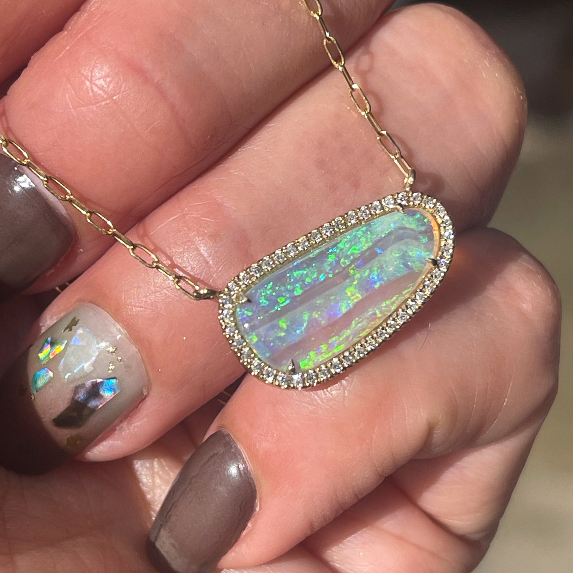 An Australian Opal Necklace by NIXIN Jewelry set in 14k gold with a Coober Pedy Opal in a prong setting.