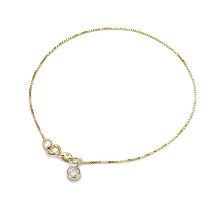 An Australian Opal Bracelet by NIXIN Jewelry against a white background. The dainty gold bracelet suspends a Crystal Opal charm.