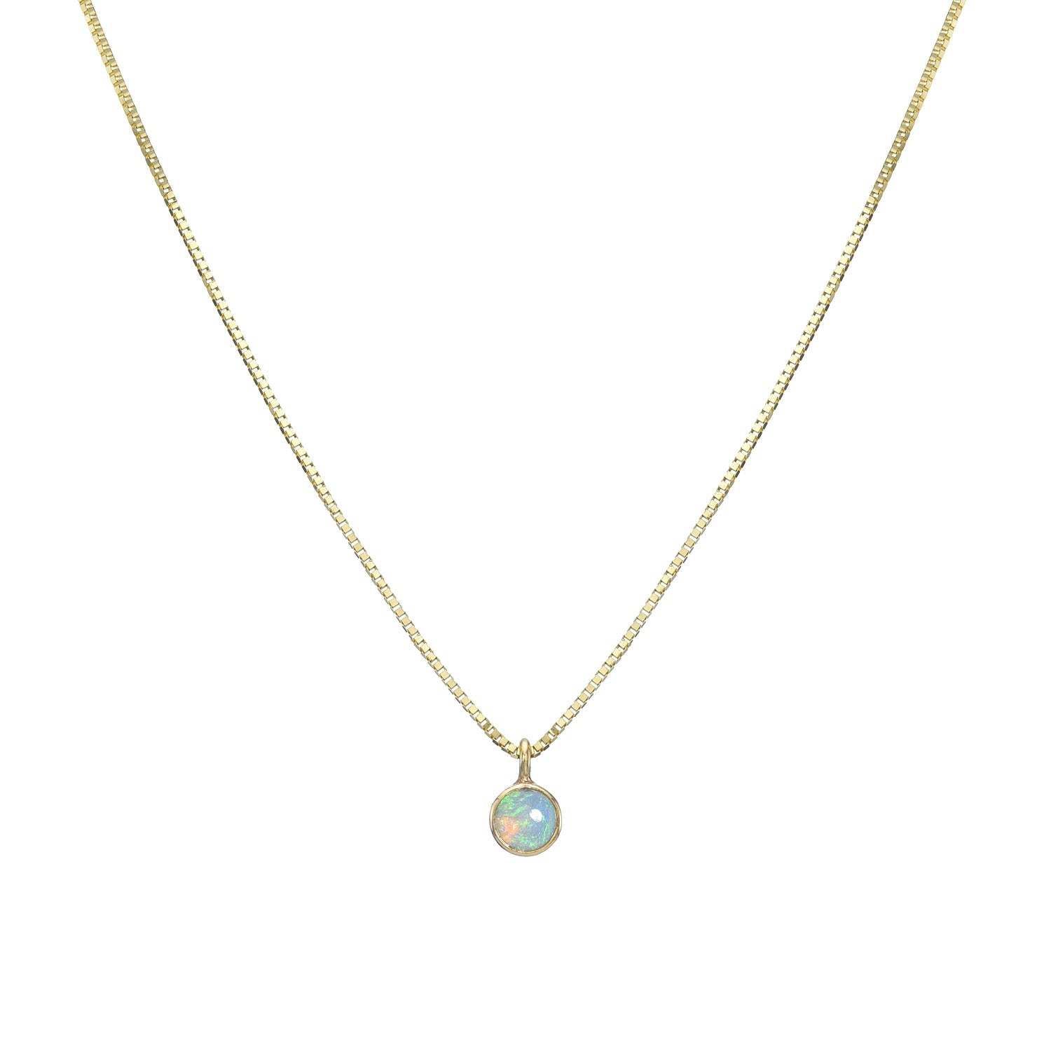 An Australian Opal Necklace by NIXIN Jewelry hangs in front of a white backdrop. The opal necklace pendant is made in 14k yellow gold with a Crystal Opal.
