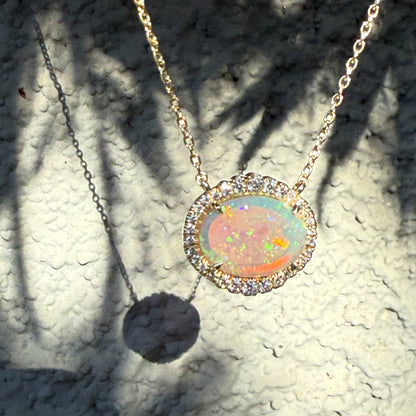An Australian Opal Necklace by NIXIN Jewelry, featuring a magnificent Lightning Ridge crystal opal in 14k gold. This luxury necklace showcases a dazzling diamond halo and represents unique fine jewelry. A premier example of opal and diamond craftsmanship for women's luxury necklace wear.