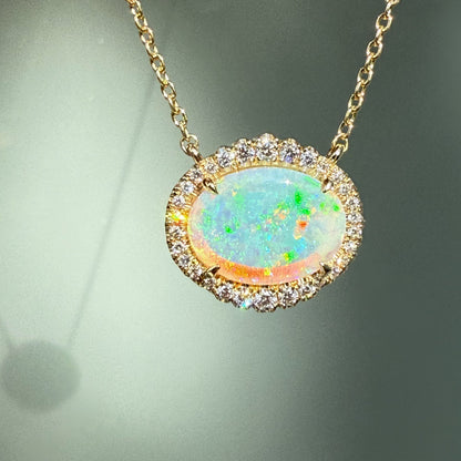 An Australian Opal Necklace by NIXIN Jewelry, showcasing an mesmerizing opal stone with a vibrant color spectrum. This crystal opal necklace, set in a halo of diamonds, offers unparalleled luxury jewelry. Explore this unique opal jewelry, a signature NIXIN piece.
