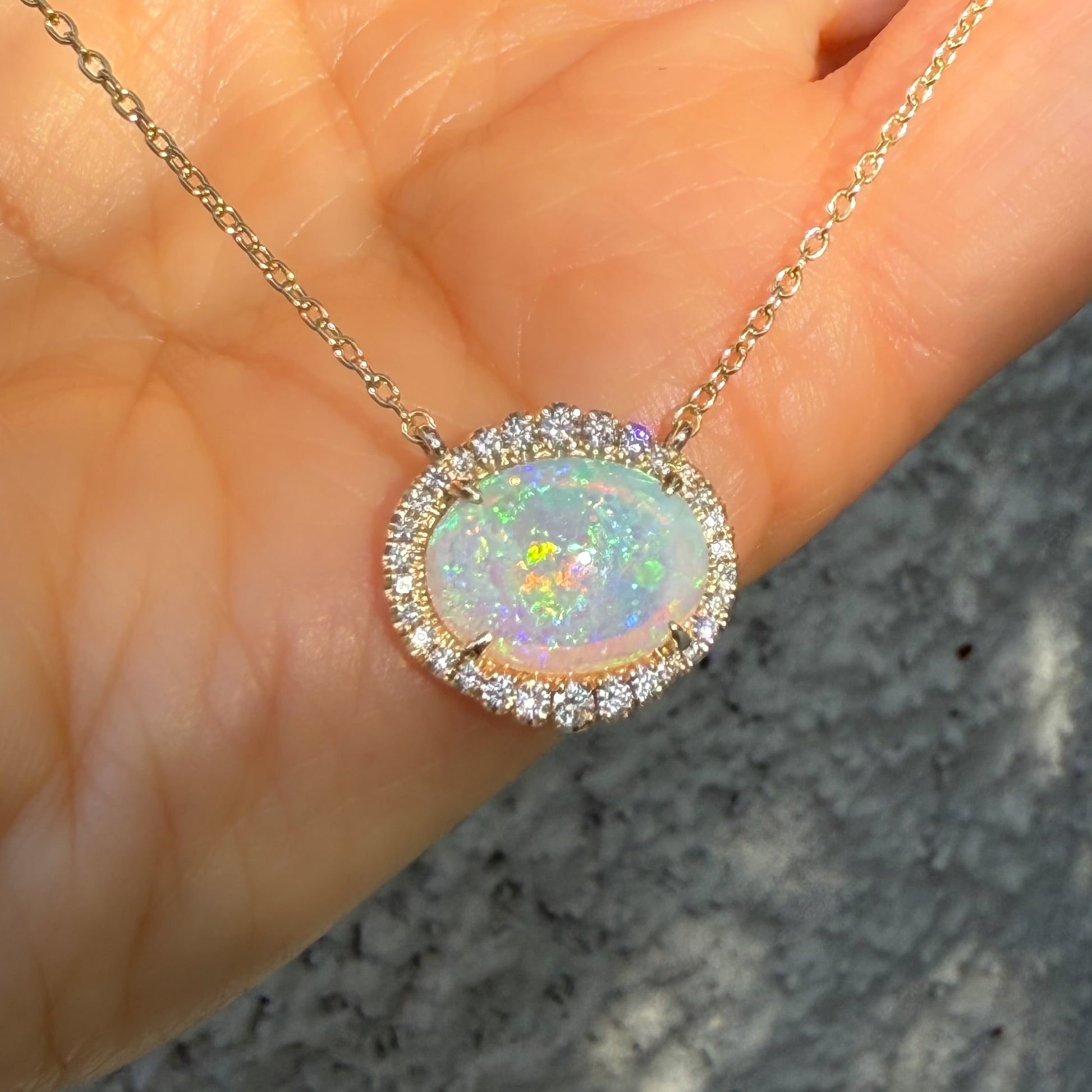 An Australian Opal Necklace by NIXIN Jewelry, presenting a stunning Lightning Ridge opal with exceptional fire. This rare opal necklace, enhanced by glittering diamonds, is a prime example of unique fine jewelry. A gold opal necklace designed for sophisticated style.