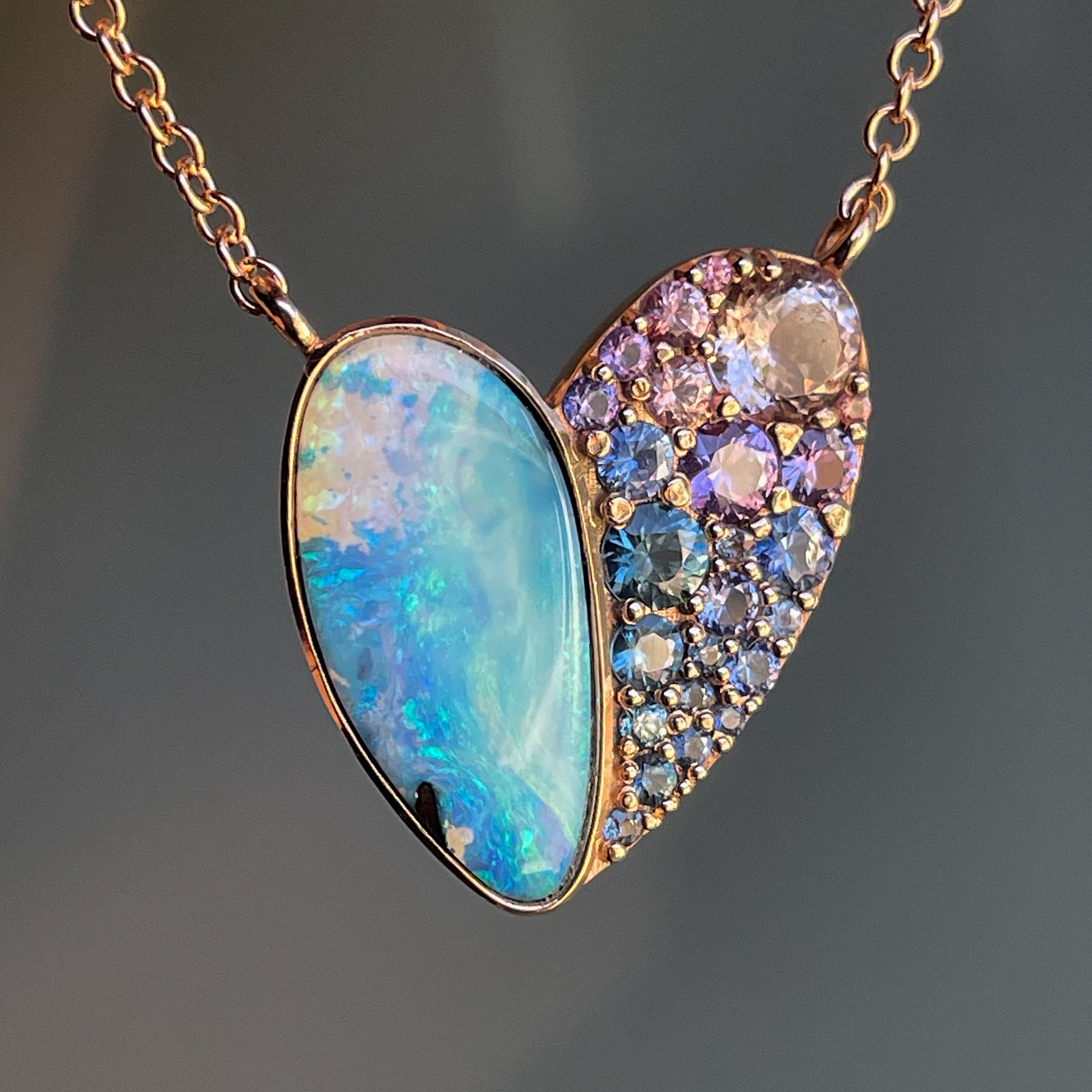 A Heart Opal Necklace by NIXIN Jewelry with an opal in a bezel setting and ombré sapphires.