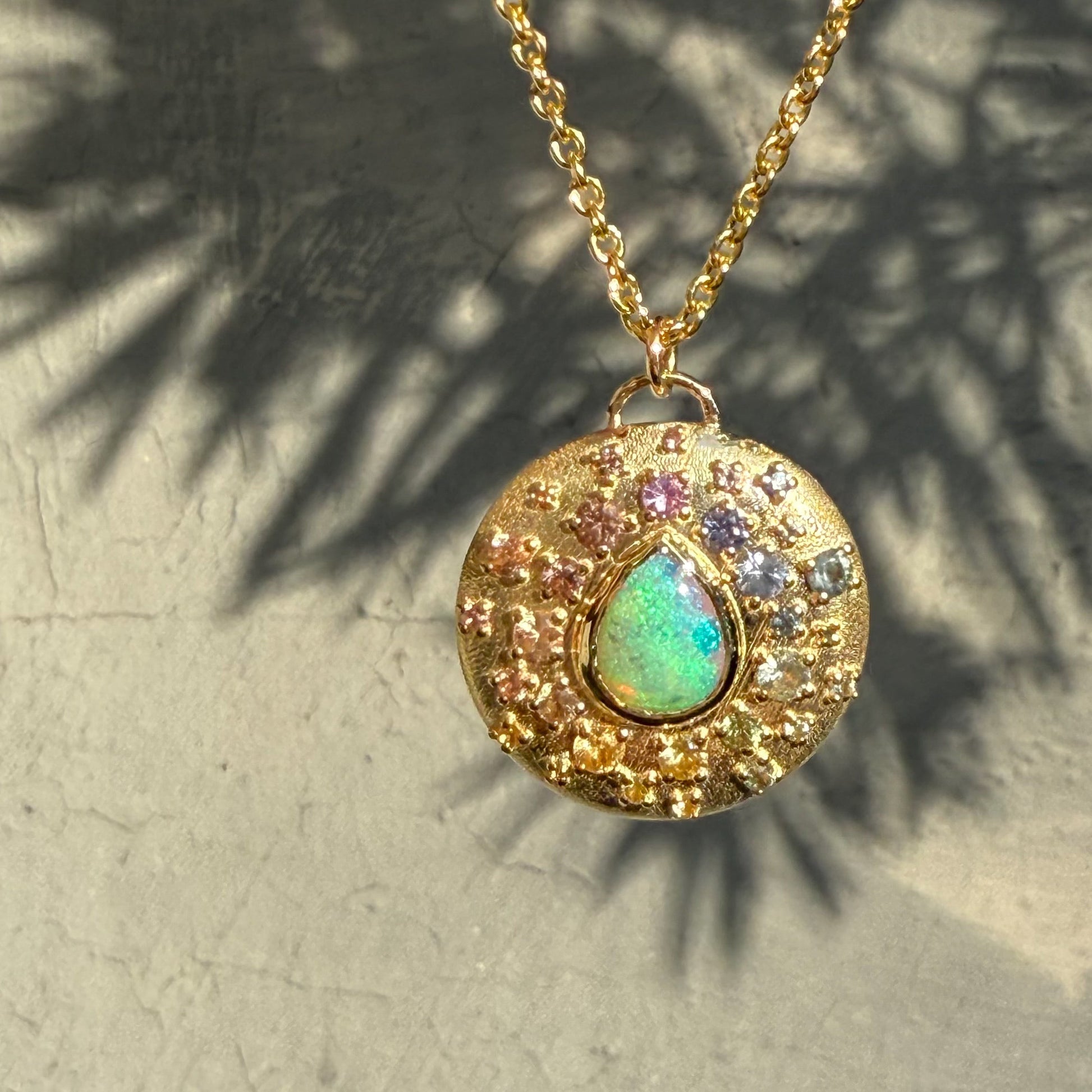 An Australian Opal Necklace by NIXIN Jewelry is a stunning women's luxury necklace. The combination of gold opal necklace and colorful sapphires creates a truly unique design.