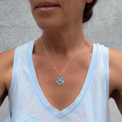 A model showcases an Australian Opal Pendant by NIXIN Jewelry. This women's luxury necklace serves as a premier example of unique fine jewelry that balances everyday elegance with high luxury. The vibrant australian opal centerpiece brings an artistic pop of color to the fine opal jewelry piece.