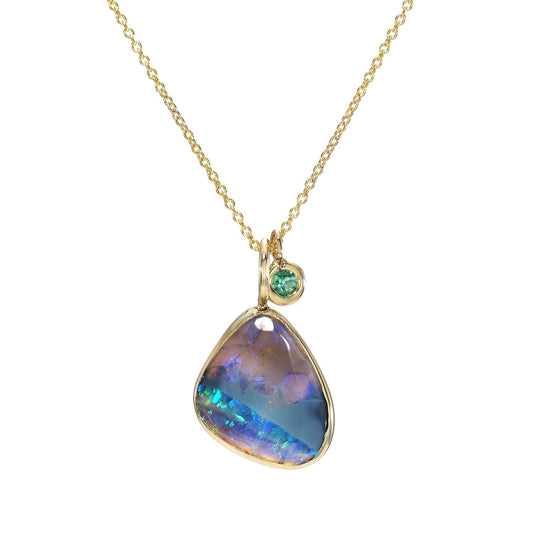 An Australian Opal Necklace by NIXIN Jewelry with a black opal and an emerald in 14k gold.