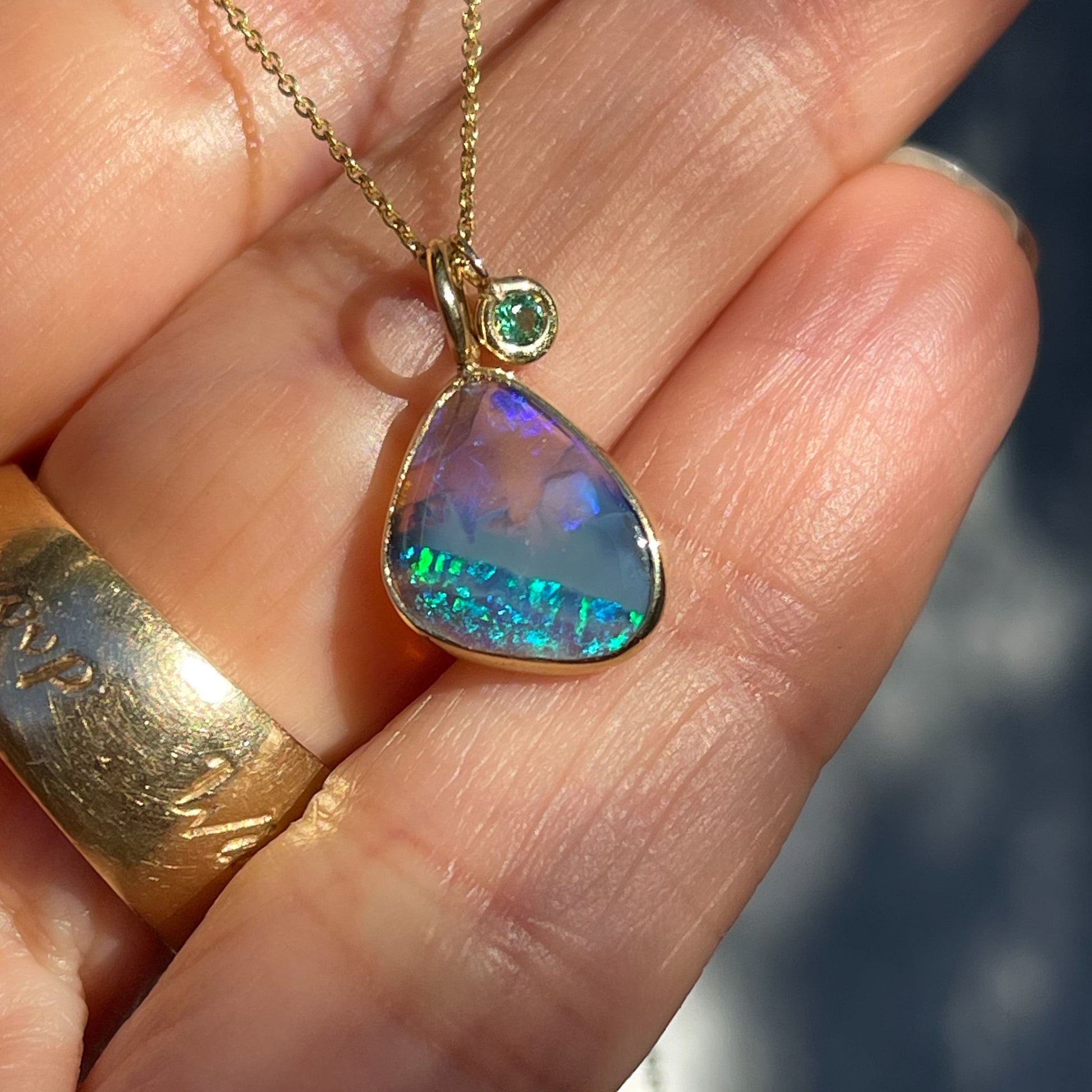 An Australian Opal Necklace by NIXIN Jewelry with a LIghtning Ridge Black Opal in 14k gold. A unique opal necklace.