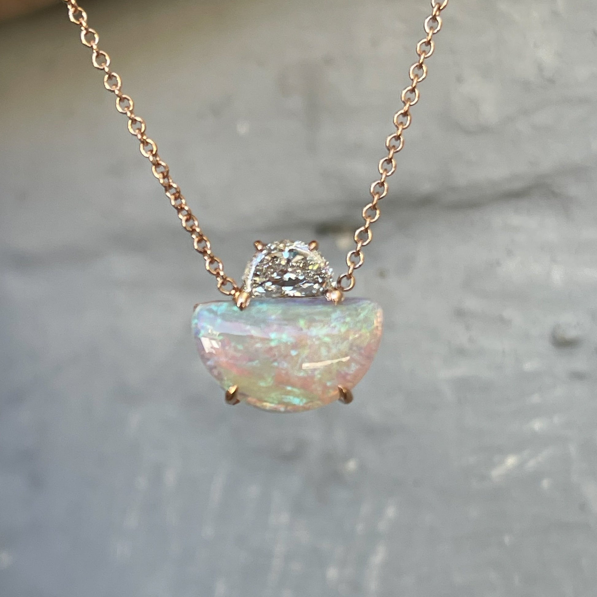 Shade shot of an Australian Opal Necklace by NIXIN Jewelry. The opal and diamond are half moon cuts.