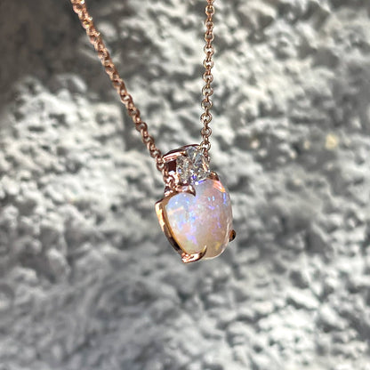 Side view of an Australian Opal Necklace by NIXIN Jewelry set in rose gold.