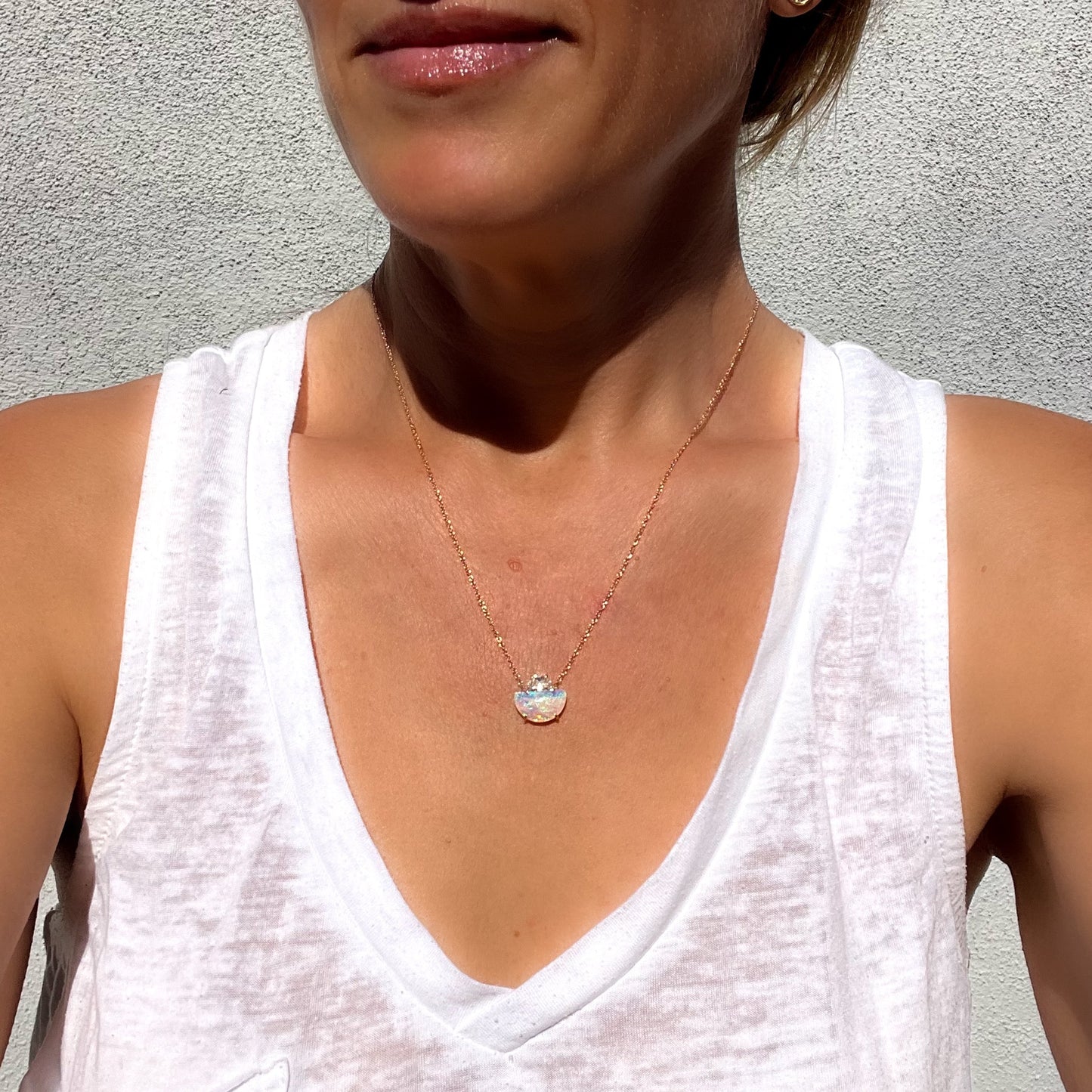 Model wearing an Australian Opal Necklace by NIXIN Jewelry. A unique opal necklace with a crystal opal.