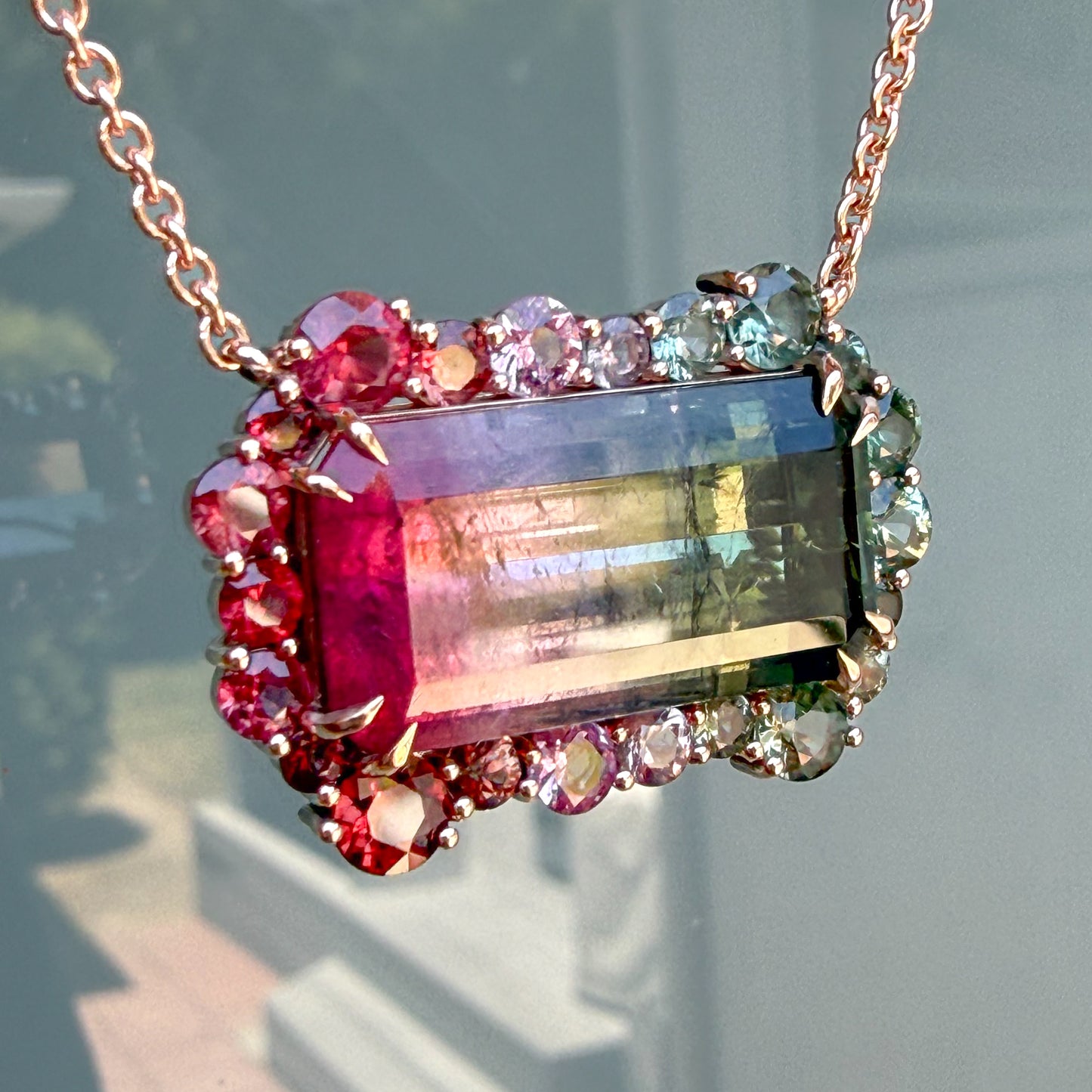 Angled view of the Empress Imbued Tourmaline Necklace by NIXIN Jewelry revealing the faceted depth of the bi-color tourmaline centerstone.