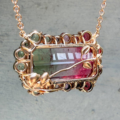 Reverse view of the Empress Imbued Tourmaline Necklace by NIXIN Jewelry revealing the secret engraving and NIXIN 14K gold hallmark with hand-finished orchid flower detailing.