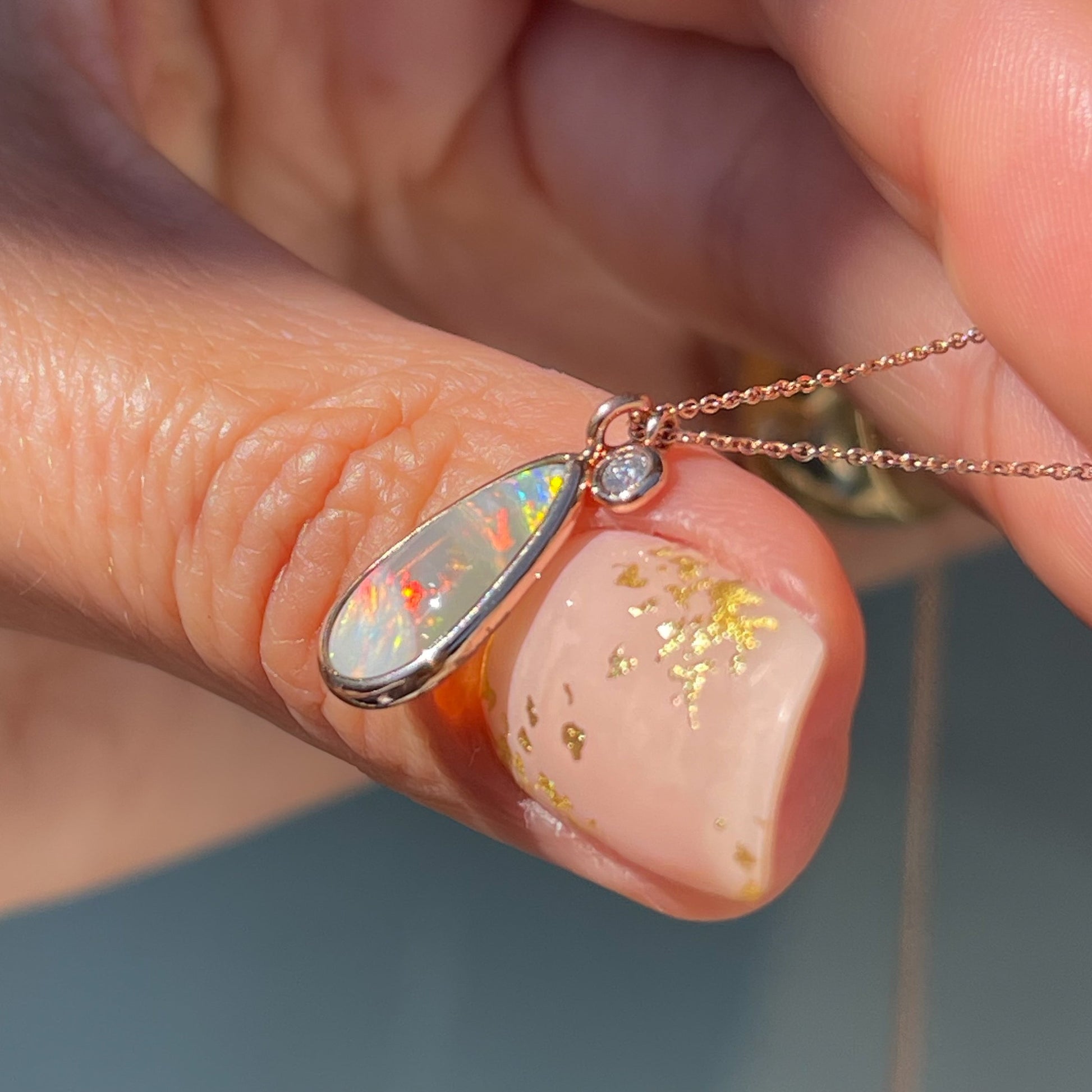 Side view of an Australian Opal Necklace by NIXIN Jewelry. Shows the opal in a bezel setting.