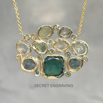  Back view of a Tourmaline and Sapphire Necklace by NIXIN Jewelry showing location of the secret engraving..