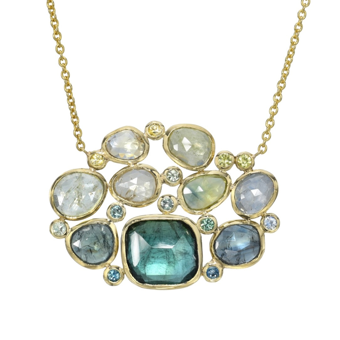 Tourmaline and Sapphire Necklace with green gemstones in gold bezel settings.