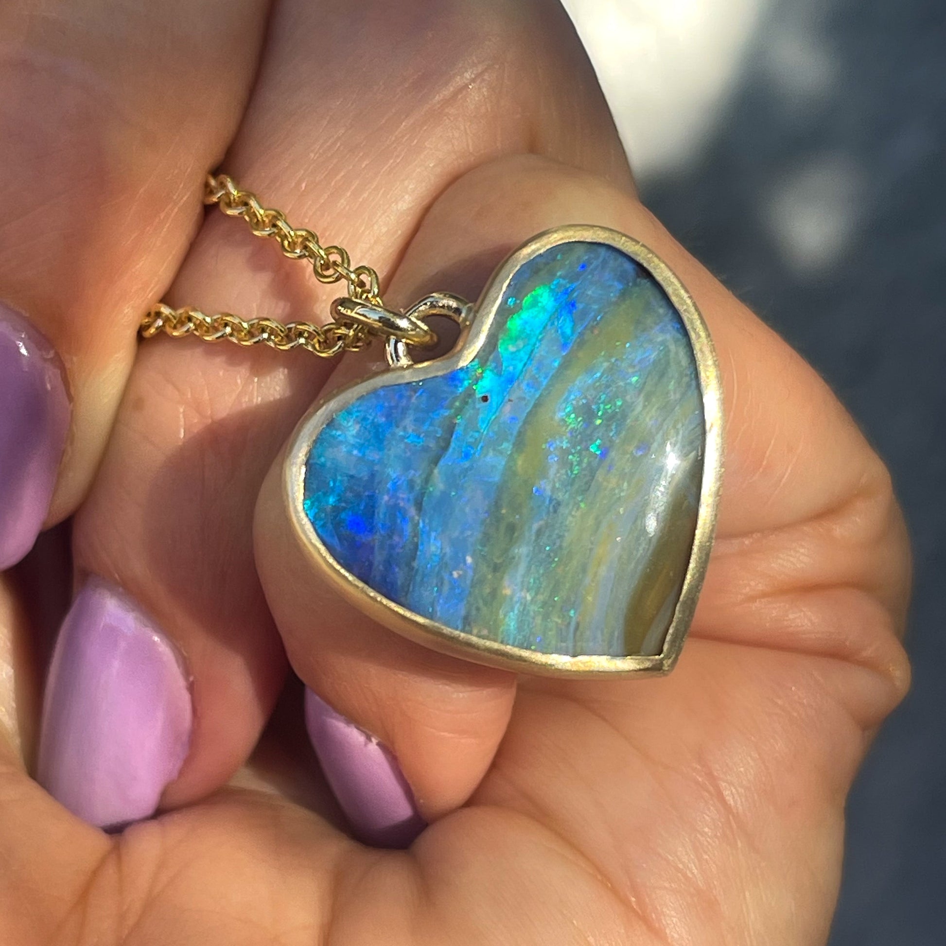 An Australian Opal Necklace by NIXIN Jewelry with a bezel set opal heart.