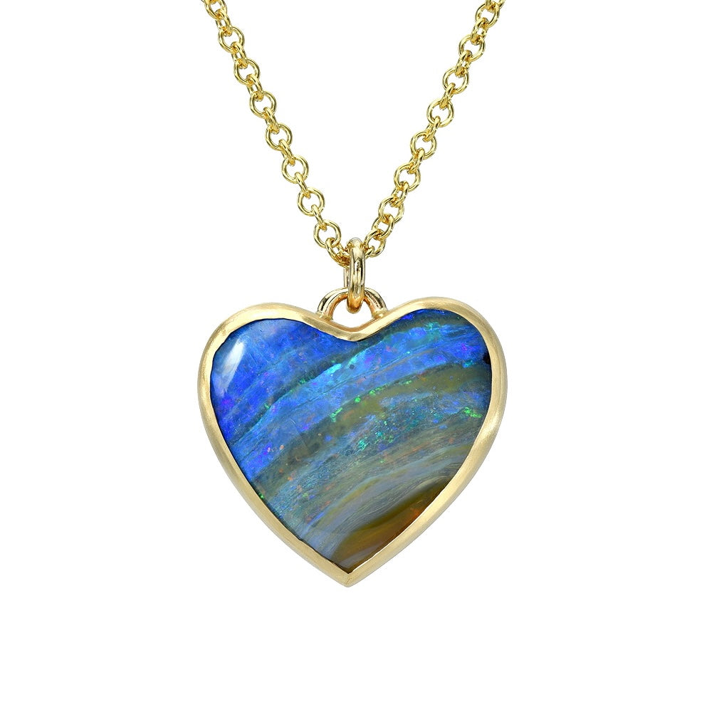 An Australian Opal Necklace by NIXIN Jewelry made with an opal heart set in a 14k gold bezel setting.