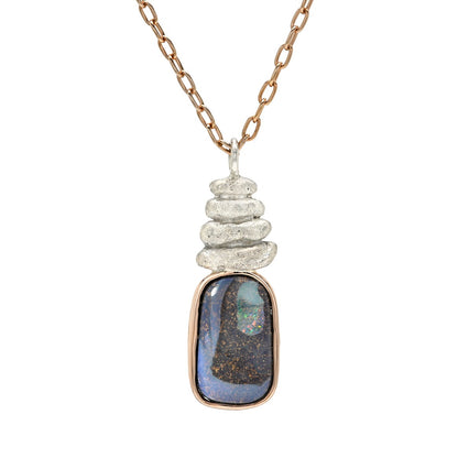 A clean studio portrait of an Australian Opal Necklace by NIXIN Jewelry presents the piece against a crisp background for a clear view of its proportions. The luxury necklace features a high-quality boulder opal that serves as a stunning opal pendant necklace. Unique fine jewelry inspired by the opal stone is a hallmark of the NIXIN Jewelry collection.