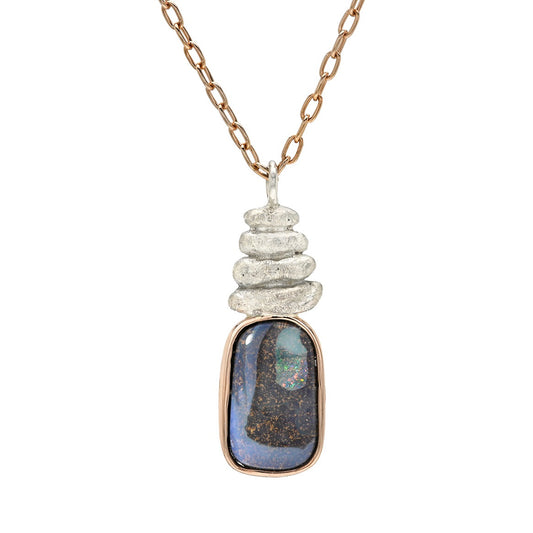 A clean studio portrait of an Australian Opal Necklace by NIXIN Jewelry presents the piece against a crisp background for a clear view of its proportions. The luxury necklace features a high-quality boulder opal that serves as a stunning opal pendant necklace. Unique fine jewelry inspired by the opal stone is a hallmark of the NIXIN Jewelry collection.