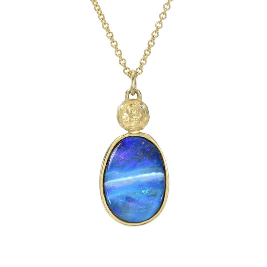 An Australian Opal Necklace by NIXIN Jewelry is displayed in a direct front view catalog image against a pure white background. This unique fine jewelry piece features a rare blue natural opal from Australia, set within a classic gold bezel, and suspended beneath a hand-textured gold moon. It is a luxurious example of unique opal jewelry.