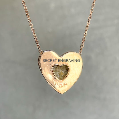 The back of a rose gold Australian Opal Necklace by NIXIN Jewelry showing a heart cut out and location of secret engraving.