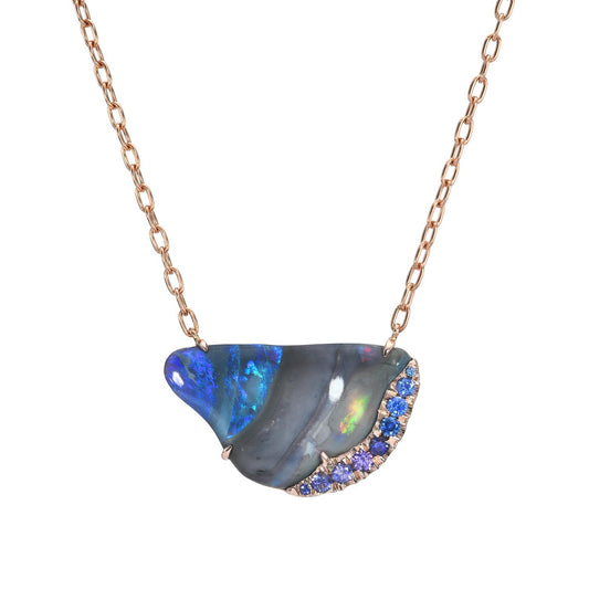 An Australian Opal Necklace by NIXIN Jewelry against a white backdrop. The sapphire and opal necklace is made in rose gold with a Black Opal.