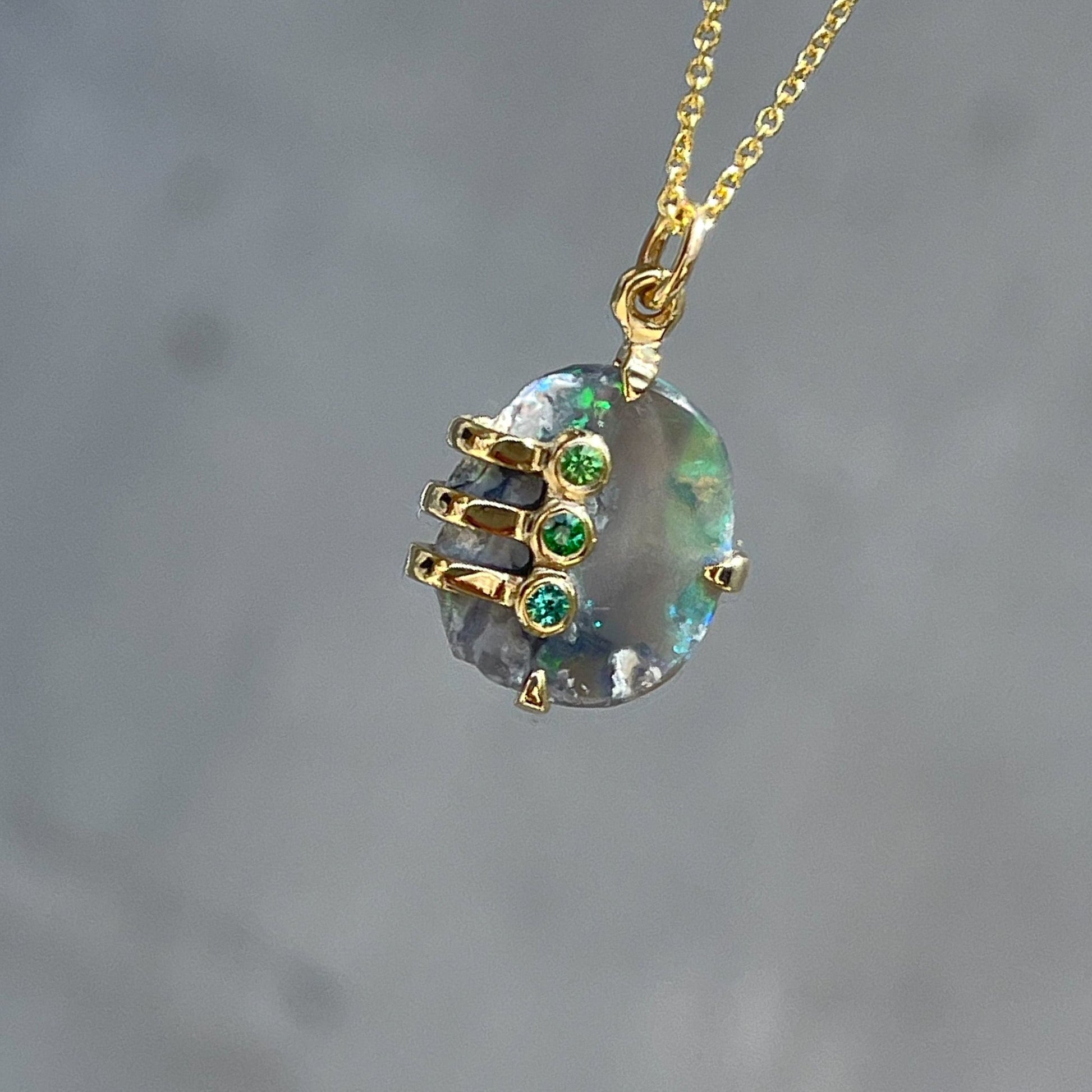 An Australian Opal Necklace by NIXIN Jewelry with a rough opal in a gold mounting. 