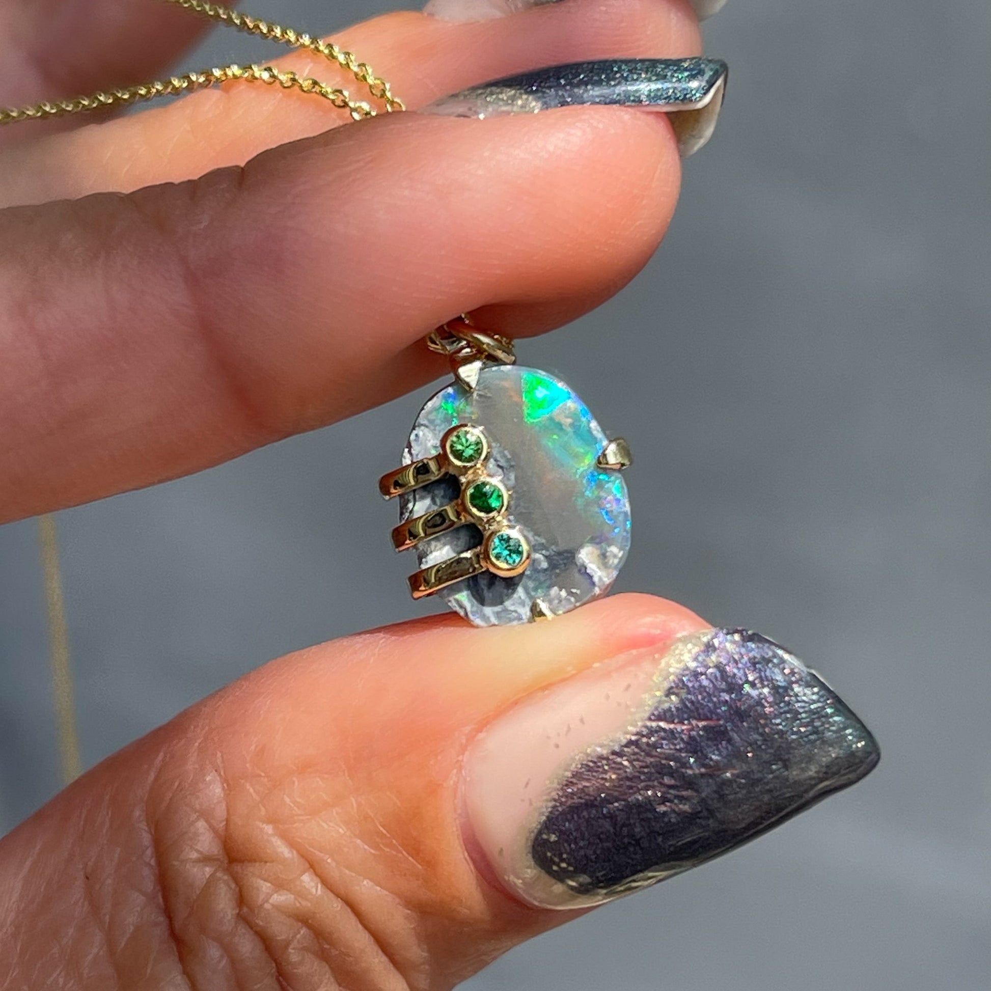 An Australian Opal Necklace by NIXIN Jewelry with a raw opal set in 14k gold. 