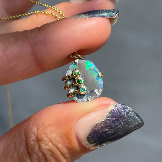An Australian Opal Necklace by NIXIN Jewelry with a raw opal set in 14k gold. 