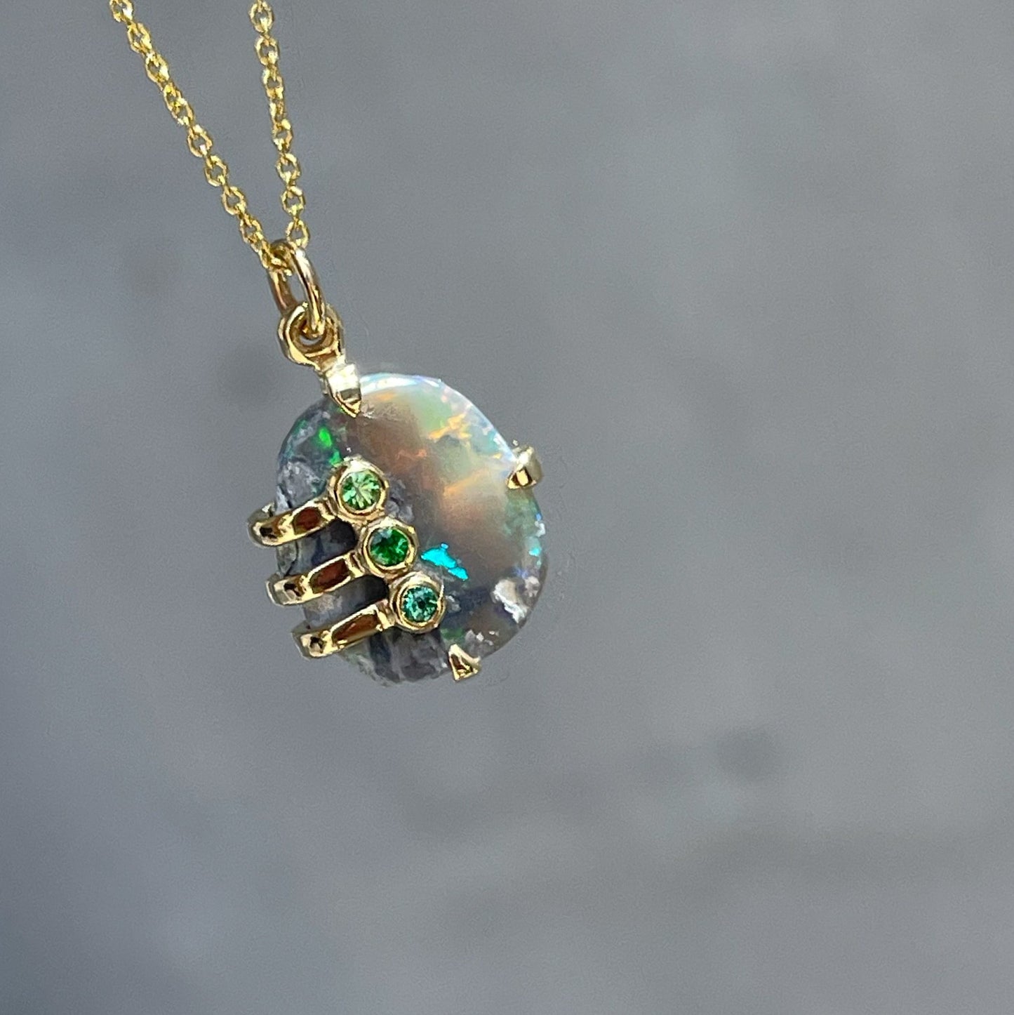 An Australian Opal Necklace by NIXIN Jewelry with a Lightning Ridge opal and tsavorite garnets.. 