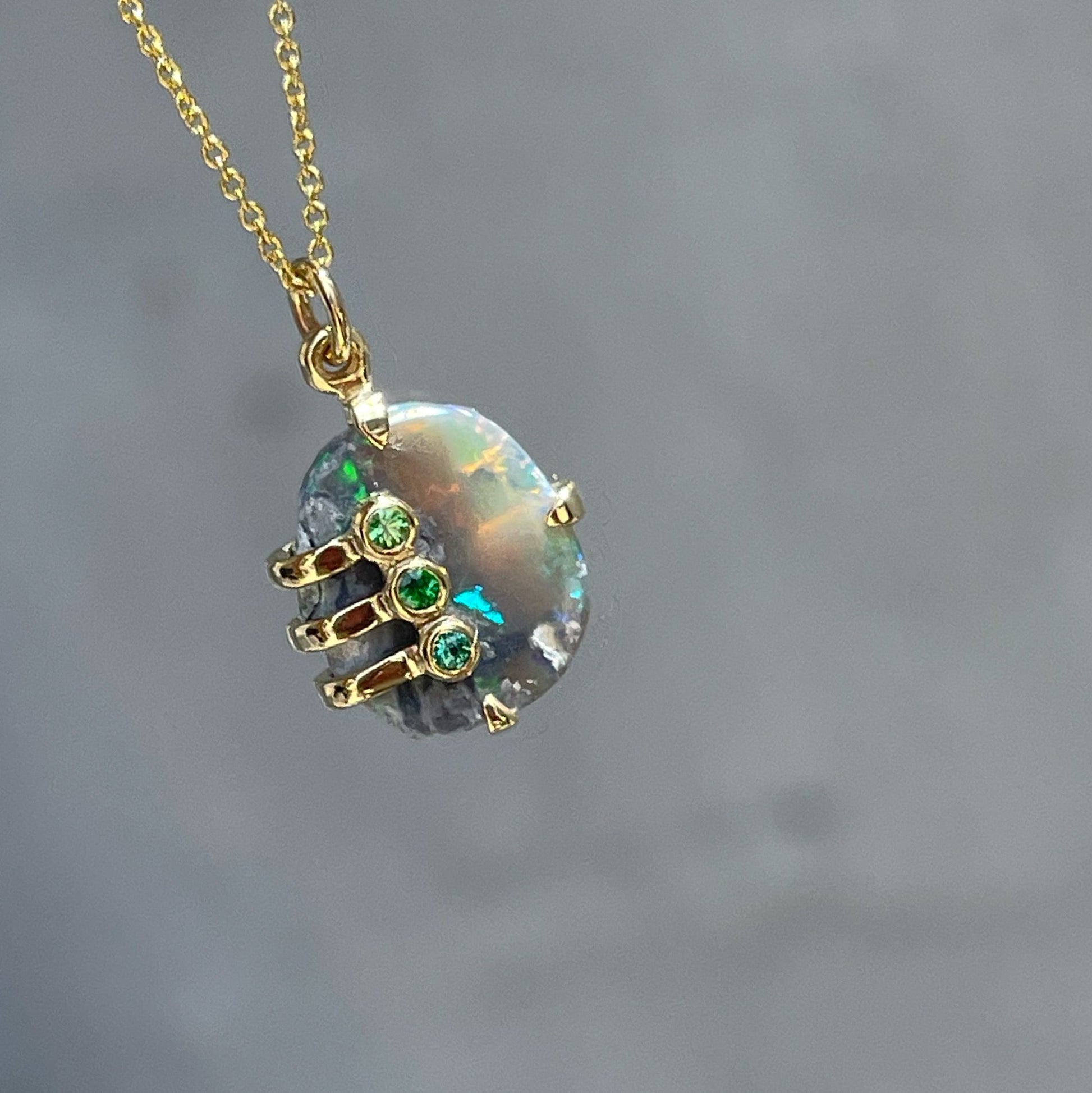 An Australian Opal Necklace by NIXIN Jewelry with a Lightning Ridge opal and tsavorite garnets.. 