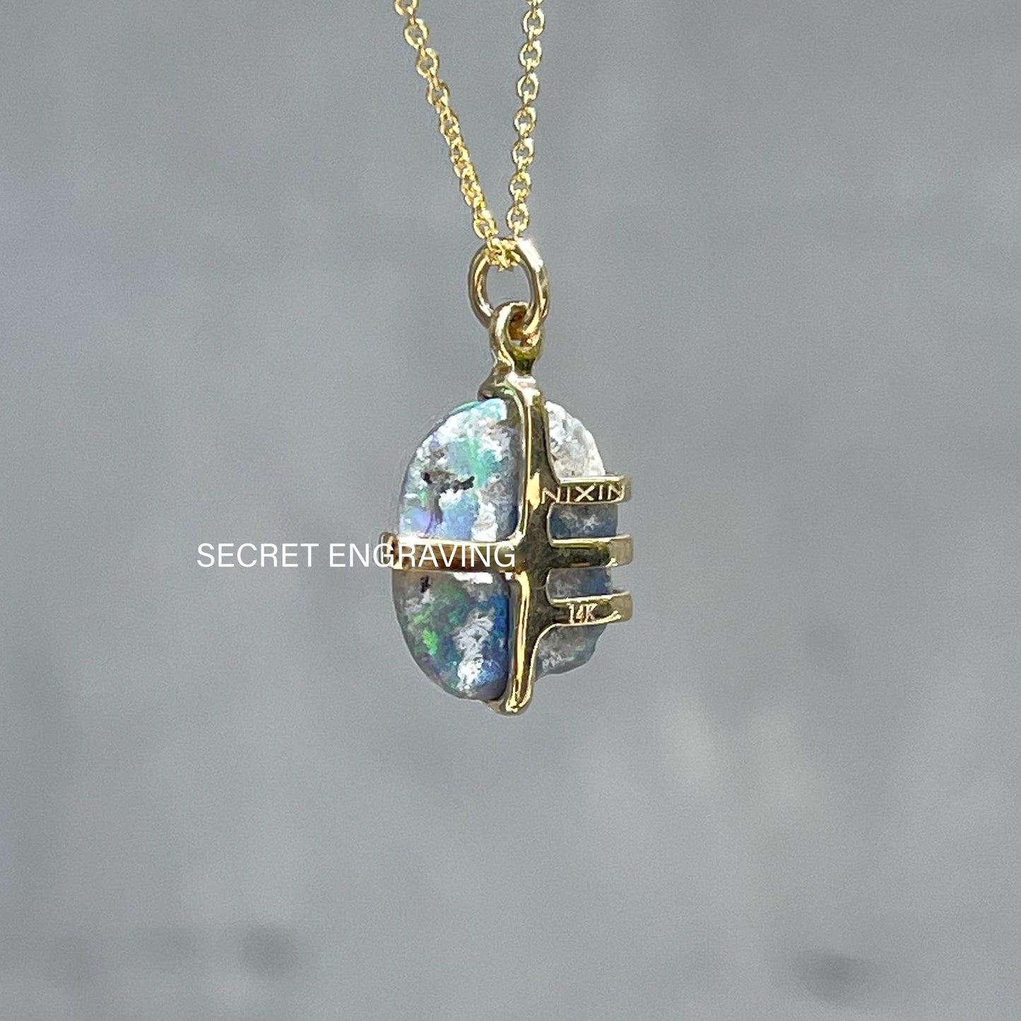 Back view of an Australian Opal Necklace by NIXIN Jewelry. Image shows where the secret engraving is on the gold opal pendant. 