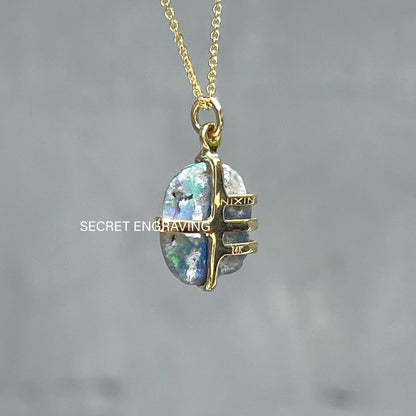 Back view of an Australian Opal Necklace by NIXIN Jewelry. Image shows where the secret engraving is on the gold opal pendant. 