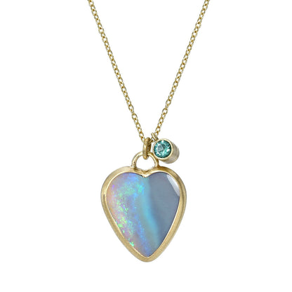 An Australian Opal Necklace by NIXIN Jewelry with an opal heart in a yellow gold bezel setting.