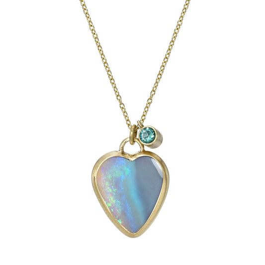 An Australian Opal Necklace by NIXIN Jewelry with an opal heart in a yellow gold bezel setting.