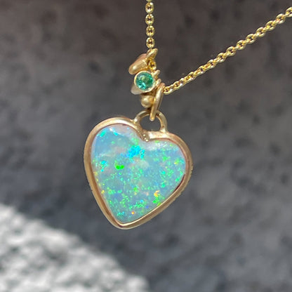 An Australian Opal Necklace by NIXIN Jewelry in a matte finish bezel setting. The opal heart is reversible.