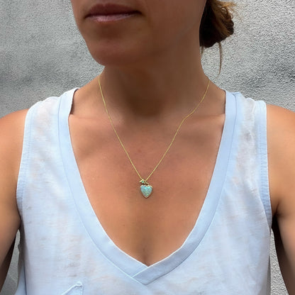 Model wearing an Australian Opal Necklace by NIXIN Jewelry to show scale. A crystal opal necklace in 14k gold.