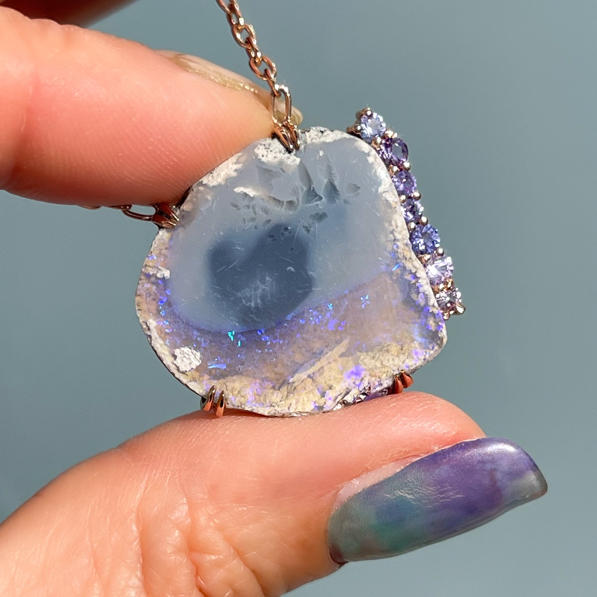 An Australian Opal Necklace by NIXIN Jewelry. A rare opal stone set into a pendant necklace with sapphires.