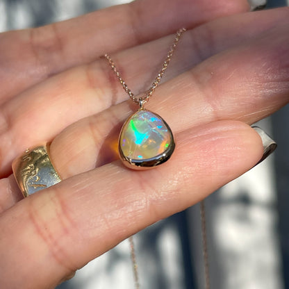 Side view of an Australian Opal Necklace by NIXIN Jewelry. The opal pendant glides on an 18" chain.