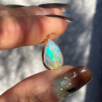 An Australian Opal Necklace by NIXIN Jewelry with a rose gold bezel setting.