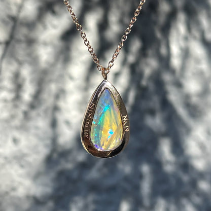 Back view of an Australian Opal Necklace by NIXIN Jewelry showing the inscription.