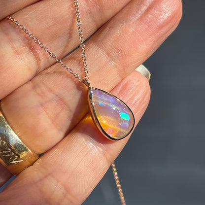 Side view of an Australian Opal Necklace by NIXIN Jewelry. The unique opal necklace is set in rose gold. 
